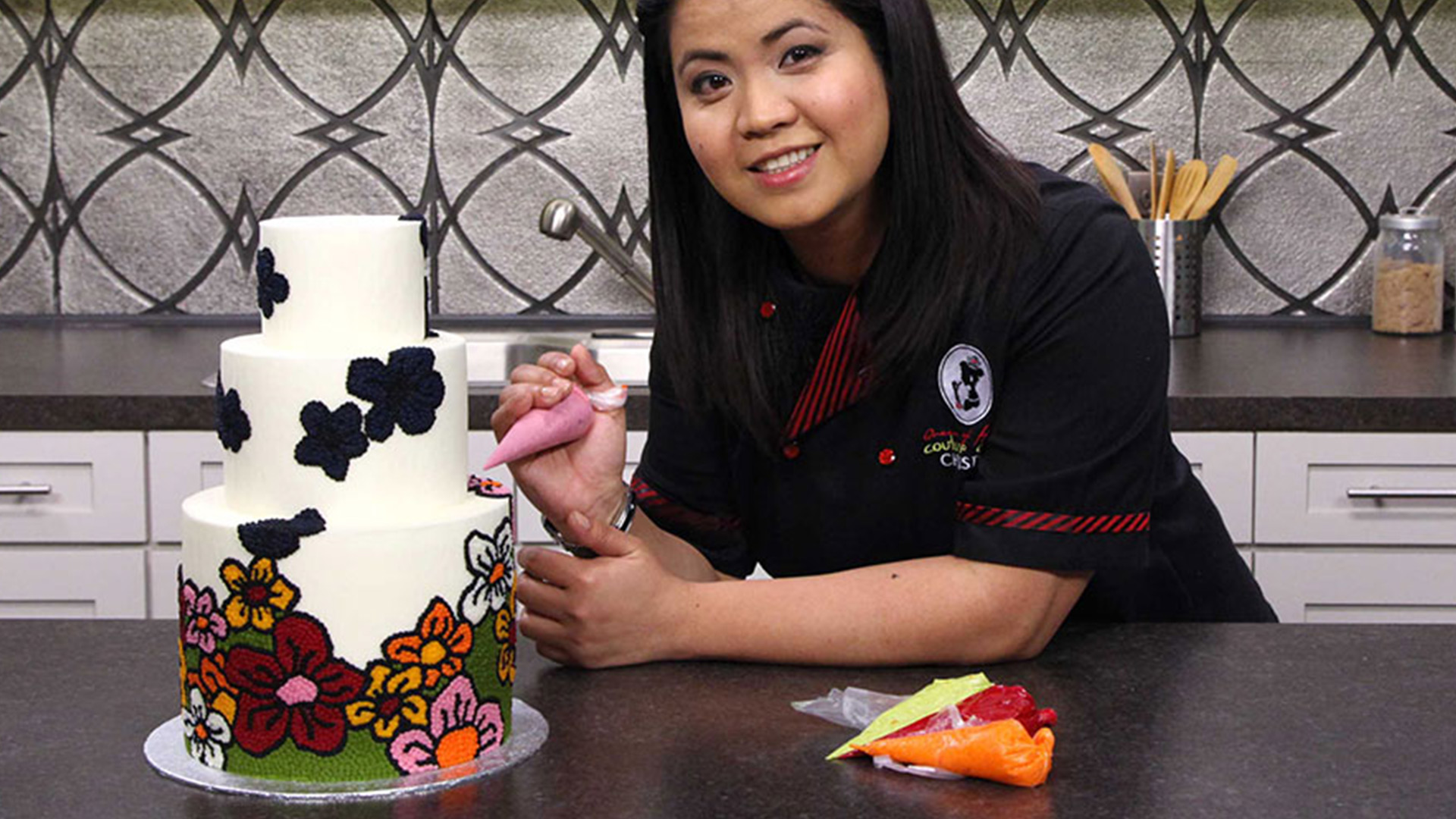 Woman coloring a buttercream cake