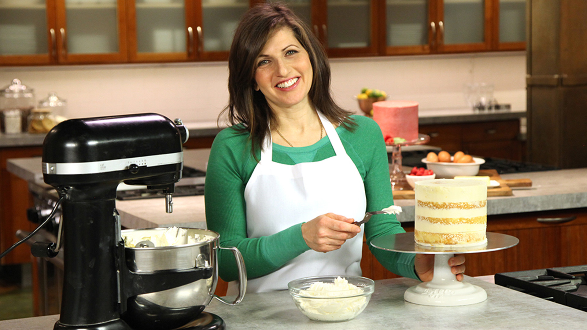 Woman frosting a cake with buttercream