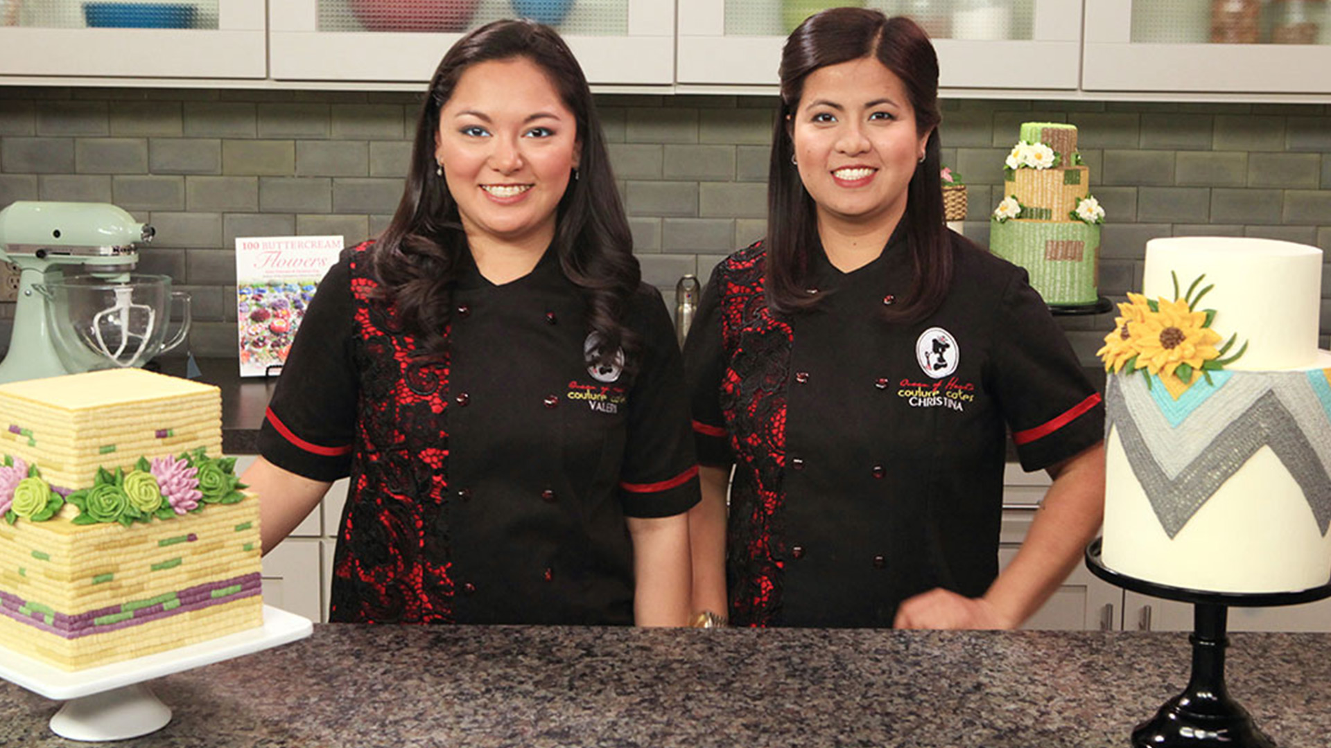 Two women with tiered decorated cakes