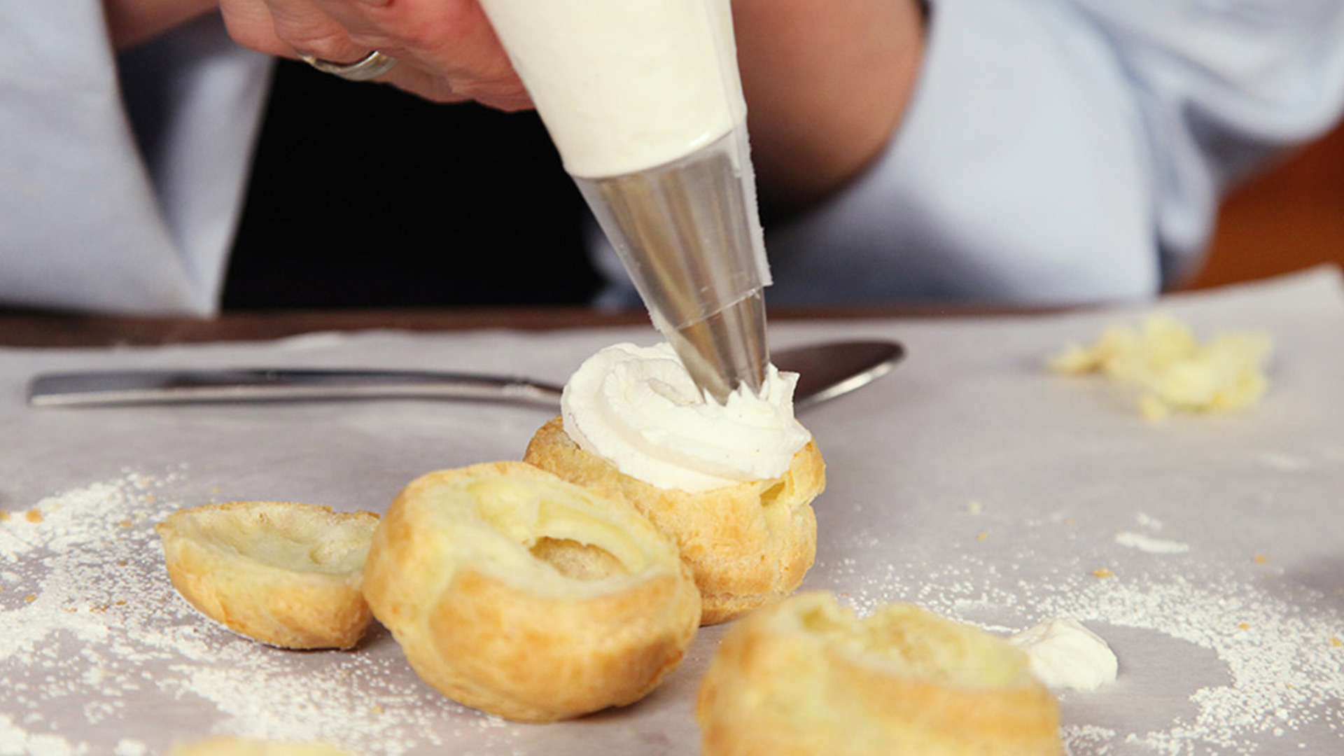Putting cream into a pastry