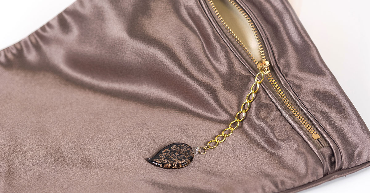 Satin zipper pouch with a decorative pull