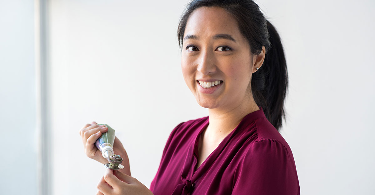 Woman making a buttercream succulent