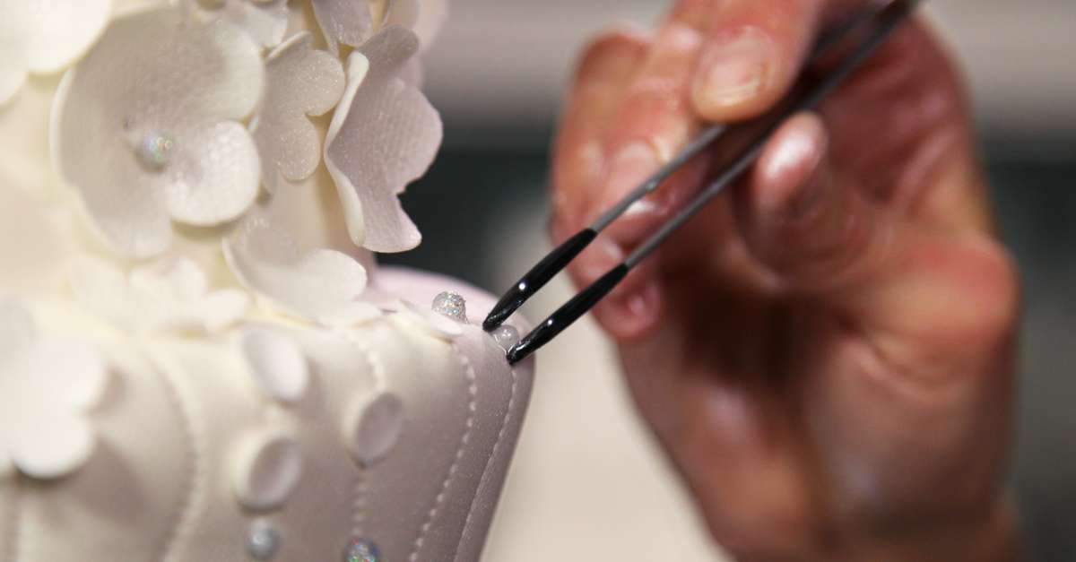 Placing gems on a white cake